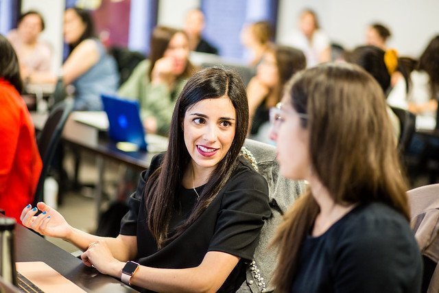 Two women speaking to each other in an Ada classroom 