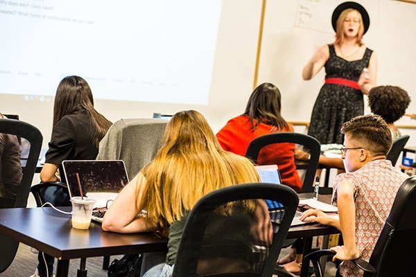 An instructor guides students during class.